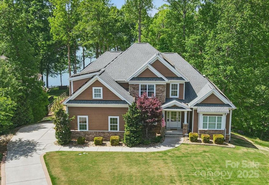 Stunning custom waterfront home in the desirable Mt. Isle Harbor neighborhood. This home offers beautiful views from the family room and most bedrooms. The main floor features a primary bedroom and a huge closet with space for an office. The open kitchen has a large island and stainless steel appliances. The guest suite on the main floor has its own private bathroom. Upstairs, you'll find four additional spacious bedrooms and two full bathrooms. The basement has a full guest suite with a bathroom, a large media room with a projector, a pool table, and a custom bar for entertaining. The basement walks out to a patio, including a rear facing garage with workshop space. Nestled in a quiet open cove, the dock offers a sense of security and privacy with its covered deck and views of the main channel. Don’t miss your opportunity to purchase this newer custom home with a large lot and gorgeous waterfront views! Additional features include energy savings monthly and security cameras.