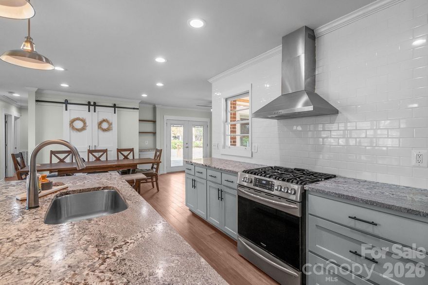 Welcome to this 3 bed 2 full bath solid brick ranch located within walking distance to downtown Heath Springs. 
this fully renovated home features a chef's dream kitchen with large island, stainless appliances, gas range, leathered granite and subway tile backsplash. This open concept home has been updated top to bottom. Off the main living room with electric fireplace you will find the first full bathroom as well as laundry room, Special insulation to help with sound dampening features. Enjoy the oversized drop zone off the kitchen and garage with fresh tile and built in. 3 bedrooms and another full bath are down the hall. Outside enjoy a greenhouse with fruit trees, as well as a chicken coup, raised garden beds and even RV hookup with dedicated amp service. This home also features 2 other buildings that can be used as storage, a workshop, even an Airbnb with some love! Across the street is an additional parcel .33 acres that will also be conveyed at the time of purchase.