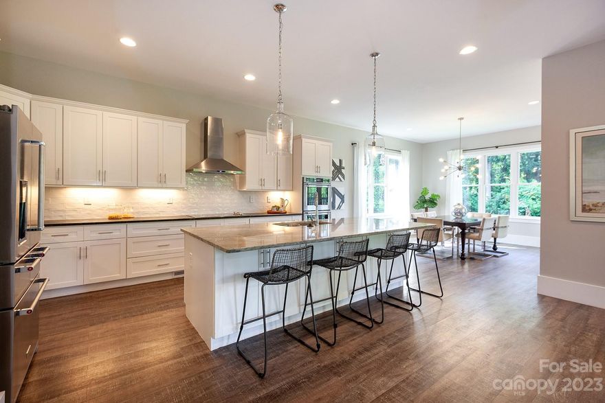 A fantastic opportunity, with a $15,000 seller credit to buyer with acceptable offer. Impressive custom 6 bedroom, 4 bath home w/basement in booming Belmont. Property borders the Little Sugar Creek Greenway, w/paths toward Uptown & Noda. Freshly painted exterior, w/charming wraparound porch & views of skyline. There's a main floor bed & bath, plus an open living room w/fireplace, & kitchen w/soft close cabinetry, a spacious island & stainless appliances. Dining room w/2 walls of windows opens to the covered back porch, prefect for outdoor dining and wired for TV. Upstairs, there's a loft, plus 4 beds & 2 baths, including the large primary suite. It has a private balcony, bath w/separate vanities, soaking tub & shower, & a stellar walk-in closet! 10 foot ceilings on floors 1 &2. In the basement, there's a gym, theatre room, family room, another bed/bath & covered patio. Fenced yard, perfect for a pool. Spacious, but exceedingly efficient. Welcome home!