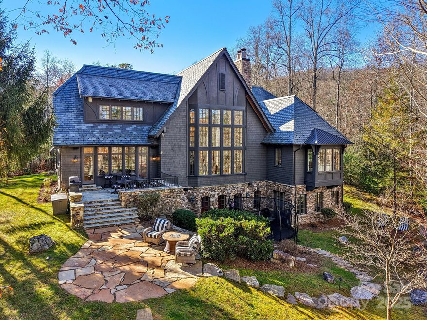 Absolutely immaculate and move-in ready, this custom 4 BR, 4.5 BA lakeside home offers stunning views of Straus Lake and exceptional craftsmanship throughout. Designed by Meyer, Greeson, Paullin & Benson, the residence showcases timeless architectural details including a slate roof, copper gutters, extensive stonework, and beautiful hardwood floors. The chef’s kitchen is equipped with premium Sub-Zero and Wolf appliances, while the serene primary suite features a beautifully remodeled bath with heated floors. Two impressive stone fireplaces anchor the main living spaces, and three well-appointed guest suites provide luxurious accommodations.

This home is thoughtfully outfitted with an extensive security system, and is fully pre-wired across all three living levels with integrated hotspot access points for seamless connectivity. Most of the home features custom adaptive two-stage dimming lighting, enhancing both ambiance and energy efficiency.

Located in the desirable community of Straus Park, the outdoor living is unparalleled, with an expansive stone patio overlooking the lake—perfect for entertaining or quiet relaxation. Additional outdoor highlights include an outdoor stone fireplace and gathering space that elevates lakeside living to its fullest. Blending elegance, comfort, and modern convenience with natural beauty, this exceptional home is just minutes from the heart of downtown Brevard, North Carolina.