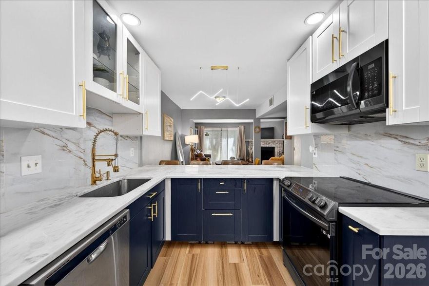 This turnkey home truly has it all- starting with an unbeatable location.  Enjoy the convenience of walking to nearby shopping and dining, all while being tucked into the desirable Raintree ne  neighborhood.  Step inside to find seamless, easy care LVP flooring throughout- no carpet anywhere.  The kitchen is the standout feature, showcasing crisp white upper cabinets paired with striking blue lower cabinets for a modern, designer feel.  Newer appliances including a sleek black oven and microwave, compliment this beautiful space.  Gorgeous quartz countertops and gold toned accents tie everything together, creating a kitchen that's as functional as it is eye catching.  The open floor plan allows a easy flow from the kitchen into the dining room and into the spacious great room- perfect for everyday living and entertaining.  The great room is anchored by a charming whitewashed brick fireplace with a white mantel.  French doors lead out to a private patio.  The primary bedroom is located upstairs and offers exceptional storage, boasting a WIC along with 2 additional closets.  The bathroom has been thoughtfully remodeled with stylish, designed finishes, creating a comfortable retreat.  The HOA fees cover lawn maintenance, parking area maintenance and water/sewer.  This property qualifies for a waived Raintree Country Club initiation fee of $30,000.