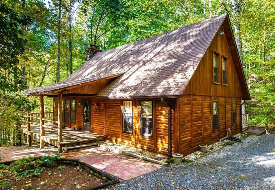 Essence of Mtn living in this Cedar log home. Rocking chair front porch greets you w/swinging bench. Exposed beams + 21' soaring ceilings sets the ambiance in the Great Rm. Efficient wood stove w/Wormy Chestnut Mantle brings warmth thruout. Master has ample closets. Bath includes jetted tub, ceiling heat lamp & antique dresser vanity. Lg. Eat-in kitchen has brkfst bar, pantry & dr. to deck. Loft is ideal for extra guests. 26' FamRm in LL has gas stove & closet for pos.BR. Laundry/workshop in LL