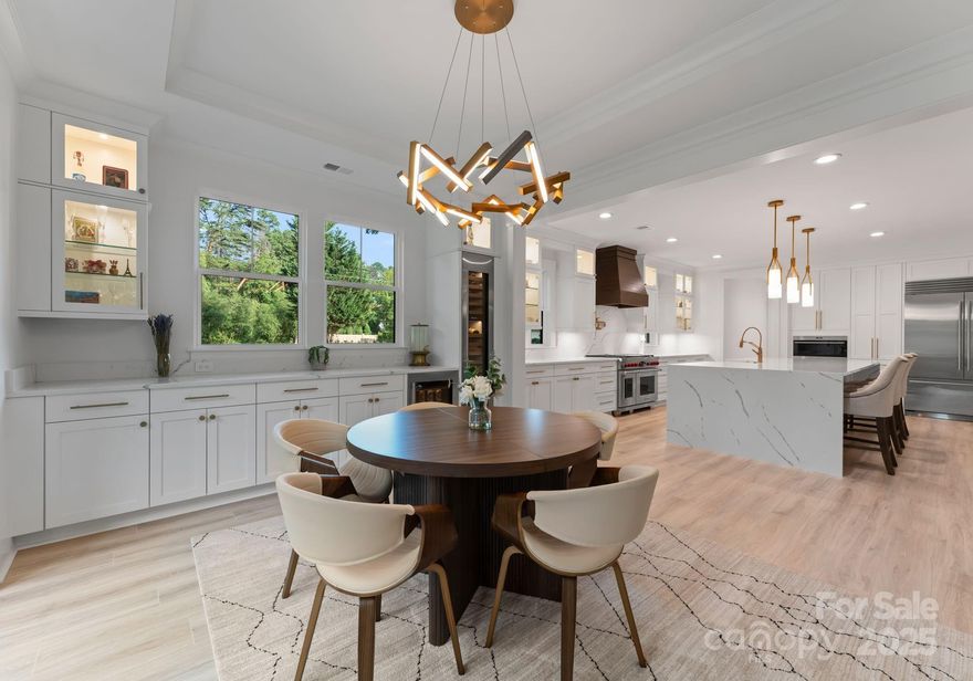 Luxury lakeside living with no HOA in this fully customized 2024 Classica Home. Spanning over 4,900 sqft, this home offers high-end finishes throughout, California Closets throughout, motorized blackout shades, and designer lighting. The chef’s kitchen features Sub-Zero, Wolf, and Cove appliances, double dishwashers, wine/beverage fridges, and a double gas range. The main-level primary suite includes a spa-like bath and private laundry. Oversized sliders open to a screened patio, professionally landscaped yard, and lake access via composite and wood steps. Additional highlights include a 3-car garage, extended driveway for boat/jet ski parking, aluminum fencing, and gas lanterns at entry. Walk-in attic on second floor. Pre-installed plumbing for pool, with electrical wiring ready for security cameras, an outdoor kitchen, and a shower. Kinetico water system and two laundry areas included. Home warranty valid through 11/1/25. Minutes from Birkdale, I-77, and top Huntersville amenities.