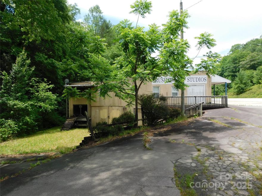 This unique property is strategically situated on Asheville Highway (NC280) just before the Henderson Co. line, which is right in the corridor leading to Pisgah National Forest. Possessing strong commercial potential, especially for businesses that cater to travelers, outdoor enthusiasts, and locals, this property has great highway exposure and steady traffic to help provide a substantial customer base. Perched on approximately .84 acres with frontage on Boylston Creek, the property boasts a natural setting complete with a screened rear porch, where clients can relax while watching trout swim. Originally built in 1949, the structure is block and concrete and includes a walkout basement offering rustic charm and long-term durability. This distinctive, creek front commercial gem, rich with history and ripe for transformation, is ready for its next chapter. Whether you envision a boutique cafe, production workshop, creative space, or retail hub, 7320 Asheville HWY offers the ideal canvas.