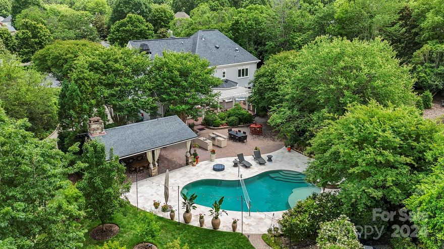 Tranquility awaits you in this ideal South Charlotte location designed with relaxation and entertainment in mind. Featuring an open deck, brick patio with a built-in service bar, hot tub, salt water pool and cabana with fireplace 
& TV. Pockets of peace are throughout this backyard haven as it is created to be low maintenance with an irrigation watering system and well established landscaping. Should you ever venture inside, this home boasts a spacious layout with four bedrooms, three full baths, formal living and dining rooms plus a cozy den w/ fireplace and built-ins. Extensive renovations included kitchen, primary suite, new closet, laundry room and a luxurious primary bathroom.The gourmet kitchen where culinary enthusiasts will delight in its top-of-the-line appliances and abundant storage space sure to impress. Tesla charging, whole house generator, self watering gardens, Sonos sound system. Your opportunity to live in Providence Country Club is here; come experience it today.