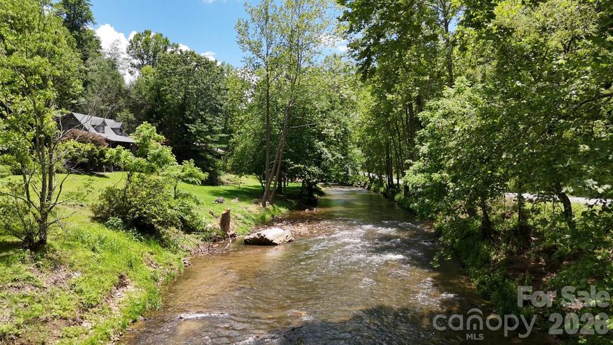 Discover the potential of this mostly wooded, west-facing homesite in River’s Edge. With shared well access already in place, this parcel offers a great opportunity to plan a full-time residence, second home, or private mountain retreat. Tucked in a peaceful setting yet conveniently located near I-40, the property offers easy access to Waynesville, Maggie Valley, and Asheville for dining, shopping, recreation, and everyday essentials. Be sure to view the virtual tour, which is a drone video of the property. It gives a much better perspective of how the land lays, the surrounding setting, and possible building sites. If you’ve been looking for a mountain parcel that offers privacy, natural beauty, and a convenient location, this one is worth exploring.