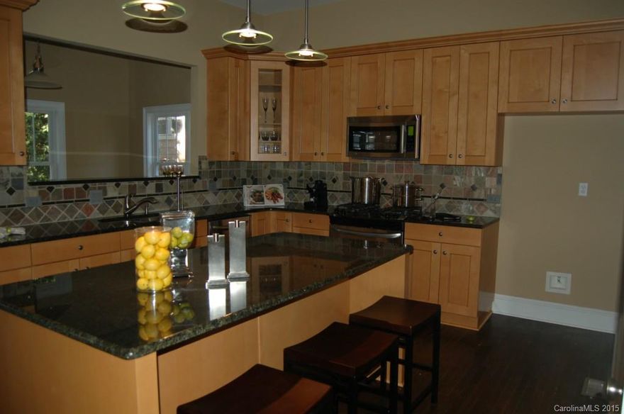 Total renovated 2007.  Discover luxury living in  Eclectic NoDa.  Double entry front door. 10' Ceilings. Kitchen w/granite counters. SS appl. Hdwd flrs. GrtRm: Floating fireplace w/custom stone. French doors. 12' vaulted ceilings. Mstr: His/her walkin closets, Jacuzzi tub, bath tile flr. sitting area. kitchen: glazed cabinets gas range w/warming drawer. Formal Living & Dining combo. Bedrooms upgraded carpet. Deck. Fenced yard. Walk to restaurants, galleries & future light rail. 2" window blinds.