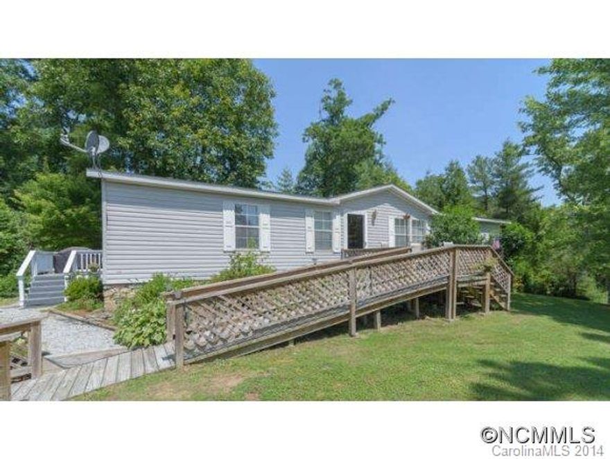 Beautifully maintained and upgraded Palm Harbor Doublewide. Top of the line in manufactured homes. 1.29 acres w/ gorgeous mtn. views.  Open plan w/ 12 ft vaulted ceilings. Sun filled split bedroom plan w/ bonus/den. Kitchen w/ eat-in dinette and breakfast bar, separate dining room. Additional parking for RV or travel trailer. 3 workshops/out buildings.  Easy conversion to 2 car garage. Swimming pool w/ deck. Meticulous stone work & landscaping.