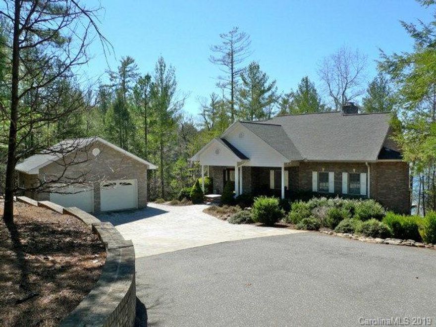 Well maintained lakefront home on a quiet cove with sunset views. Informal living, dining and kitchen areas feature cathedral ceilings and double sided stacked stone fireplace with built-ins. Entertain guests at the large kitchen island with bar seating. Dining and living rooms open to over 600 sf of deck with lovely lake views. Deck is done with composite decking and also has a large retractable awning. Large master suite has sitting area with stone fireplace that also opens to the deck. Lower level is perfect for guests with a large family room, cozy stone fireplace, two bedrooms, one with a private bath and another hall bath. Additional semi finished room is great for overflow guests or lake toy storage. Covered gazebo, single slip with lift and jetski dock. Bathrooms all freshly painted