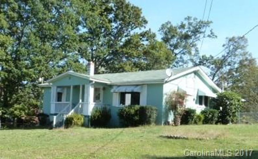 West Asheville Mini-Farm on .78 Level Acres  Bring your goats, dogs, and chickens!    Convenient county location, less than 10 minutes to downtown Asheville. This 1950’s ranch has a large kitchen, spacious living room, 3 bedrooms, I bath, and laundry/utility room.  Plus a 12’ X 6’ front porch, 30’ X 8’ 3-stall outbuilding, walk-out basement with plenty of room for freezers and canned goods, new HVAC system, insulated windows, two septic connections, and is totally fenced, and cross fenced.  New carpet has been ordered and is being installed in bedroom within the next two weeks.