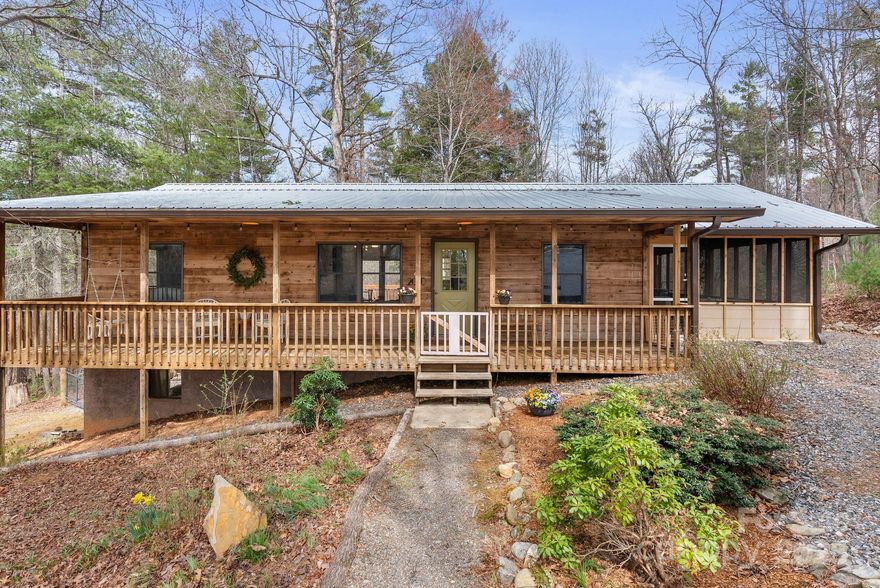 HIGHEST AND BEST OFFERS ACCEPTED UNTIO 6:00 PM SAT. APR. 12th.  Charming 2 / 2 home, tucked away from the road on idyllic 3.4 OU acres. Thoughtful, modern updates and open floor plan. A large, screened side porch with stylish, hand-stenciled floor makes a cozy hangout, complete with hot tub! Dining area opens to a back deck with privacy and a woodland view of partially fenced backyard. Plenty of storage in the main floor laundry room.

Front porch is surrounded by native plants and Japanese maples. By driveway is over .25 acre cleared area, could be potential build site, buyer to verify.  Circular driveway provides easy access and parking. Wildlife frequent the property - deer, turkeys, woodpeckers and rare songbirds.

Huge, bright unfinished basement with high ceilings includes a one car garage and ample workshop or studio space. New water heater installed in 2024 and new dishwasher in 2023. ADT Security system available.
This special Weaverville charmer is move-in ready!