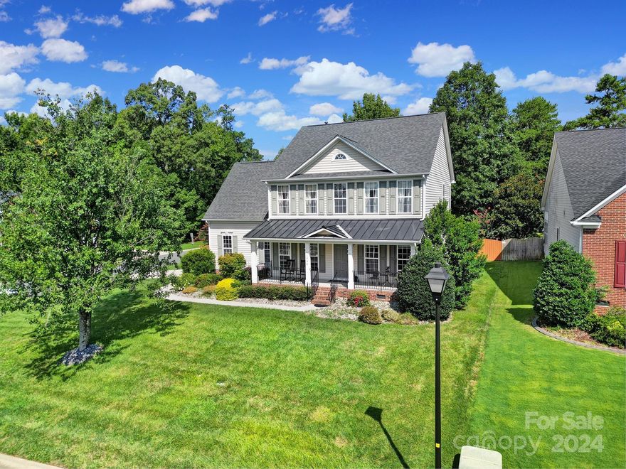 Welcome to your dream home! This stunning Fort Mill residence occupies a desirable corner lot. An elegant two-story foyer welcomes you inside. Hardwood floors grace the main level, leading to a formal dining room and a private office with French doors. The gourmet kitchen is a chef's delight, featuring 42" custom cabinets, a gas stove, double wall ovens and an open layout perfect for entertaining. Relax in the living room by the cozy stone-lined fireplace or unwind in the sunroom bathed in natural light, looking into the manicured lawn and deck. Upstairs, the luxurious primary suite offers a relaxing soaking tub and low-maintenance LVP flooring. Two additional bedrooms provide ample space. The bonus room is perfect for movie nights! The fully fenced backyard is an outdoor retreat, while the front yard showcases a tranquil rock garden and fountain. Conveniently located close to highly rated schools in the award winning Fort Mill school district. Make 1054 Sora Lane your new home today!