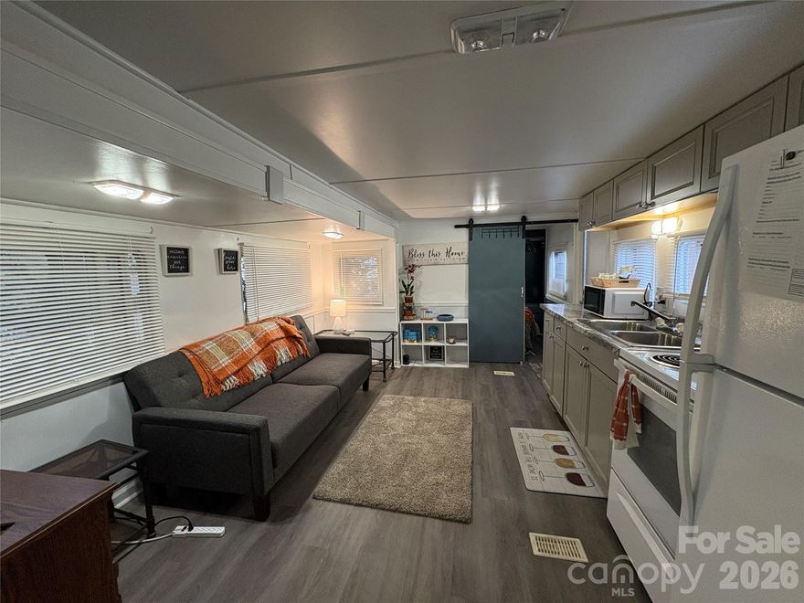 Welcome to lake living made easy in the highly sought-after Badin Shores Resort! This deeded lot features a beautifully remodeled camper that feels more like a cozy cottage than a traditional RV. 
Completely transformed inside, this home offers an open and airy layout with "camper furniture" removed in main living area to maximize space and comfort. The kitchen area is a standout with a full-size stove and full-size refrigerator — perfect for everyday living or weekend entertaining. You’ll also find two bedrooms and one full bath featuring a full-size shower and standard residential toilet for added comfort. The original camper HVAC has been replaced with a standard HVAC system, enhancing efficiency and year-round enjoyment. 
Step outside to an expansive deck designed for outdoor living. All furniture remains, including the pergola and outdoor furnishings, making this property truly move-in ready. The generous lot provides ample parking for your boat, vehicles, and golf cart / ATV. A storage shed offers additional space for lake gear or golf cart parking. 
As an owner in Badin Shores Resort, you’ll enjoy an abundance of amenities including a swimming pool, fishing pier, basketball & sand volleyball, putt-putt, horseshoes, disc golf, community beach, boardwalk, clubhouse, playgrounds, and picnic pavilions. 
Whether you're looking for a weekend retreat or a low-maintenance lake escape, this property delivers comfort, space, and the ultimate resort lifestyle.  CASH Sale Only!