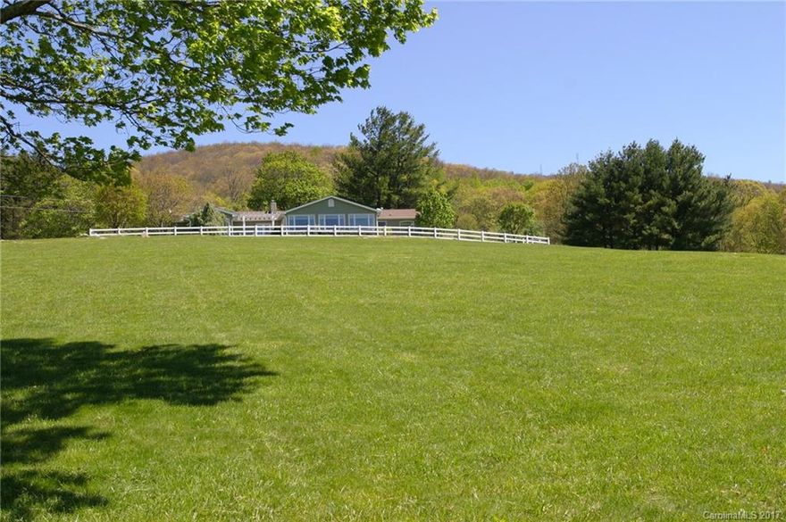 Three Meadows Farm is a magical mountaintop retreat with open fields, private pond and sweeping vistas. Just 12 miles to Asheville, the enchanting farm boasts eclectic, updated main home with 2 master suites, cute guest cottage, rare mountaintop setting at 3600-ft elevation, and spectacular 240-degree unobstructed views. Includes barn building, riding ring, established grass, mature landscape. Highly productive mountain spring originates on the property. Unsurpassed ambiance. Pristine condition.