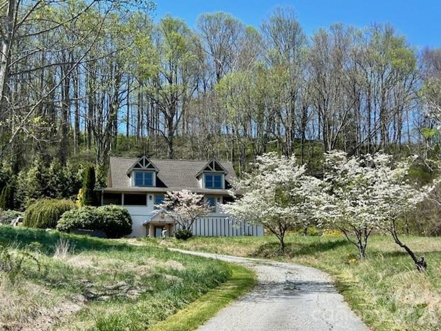 This knoll-top Contemporary Cape Cod home sits on a 1.59 acre lot with east-facing year round mountain views. The timeless design and functional layout provide a foundation with considerable potential. This three-bedroom, four-and-a-half-bathroom home presents an exceptional investment opportunity with stunning mountain panorama views and sunrise vistas. The covered mountain-view porch provides an ideal outdoor retreat, while mature evergreen borders to the rear and a private patio fire pit area enhance the property's natural appeal. Other features include an outdoor kitchen, sunroom, unique enclosed grill room, unfinished detached guest house with loft and its own full bathroom. Partially finished basement has a wet bar/rec room, mudroom, bonus room, playroom, laundry, full bathroom and workshop space. There is an outdoor shower and a private enclosed firepit patio area. The home features mountain view windows and a sun-filled 2 story living room that showcase the seasonal foliage display throughout the year. Located close to Lake Junaluska Golf Course, with convenient access to Lake Junaluska Recreation Area and Maggie Valley Festival Grounds, this property offers both recreational amenities and location advantages. With solid structural foundation and classic architectural elements, this home provides an excellent canvas for transformation. The combination of natural beauty, recreational access, and generous bathroom count establishes strong potential for a successful renovation project with substantial upside value for discerning investors. This is a Fannie Mae HomePath property.