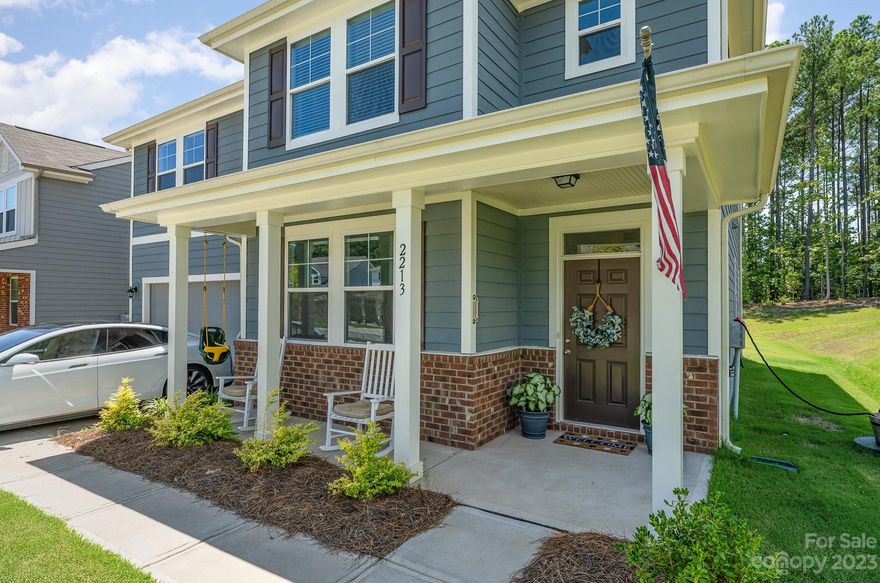 Move In Ready Home, Nestled in the charming community near Lake Wylie and Allison Creek Park, this exquisite Charleston-style home captures the essence of southern elegance and modern comfort. This two-story residence offers a seamless fusion of sophistication and relaxation. The main living area seamlessly combines the living room, dining room, and kitchen, creating a space that's perfect for entertaining family and friends. LVP floors run throughout, adding warmth and character to the interior. The living room is bathed in natural light, thanks to large windows that offer views of the lush surroundings. A cozy fireplace, providing both visual appeal and comfort during cooler evenings. The primary bedroom is oversized with seperate his and her walk in closets, 3 additional large bedrooms seperated with a quaint activity space, great for entertaining. This home has one of the largest lots in the community, with just under 1/2 acre and flat, perfect for a pool or what you can vision.