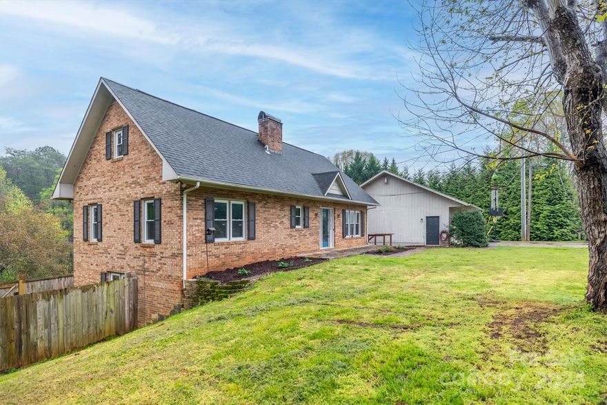 Spacious brick home with 4 bedrooms/2.5 baths on nearly an acre! This home offers the following: wood/tile flooring throughout, replacement windows (2024), water heater (2023), HVAC (2023), garage re-roofed (2023), mini split (2021). On the main level, you will love the large primary bedroom with a full bath, two more ample-sized bedrooms, and plenty of closet space. Spread out in the fully finished basement with a fourth large bedroom, full bath, laundry, sunroom, living room with fireplace, large storage closet off the kitchen, and dining area. A 900 sq ft detached garage with a bathroom, wood stove, and lean-to style attached double carport! Outside also enjoy the partially fenced backyard, level front yard, fire pit area, and creek at back of the property. Need more space...there are stairs up to the huge unfinished floored attic!