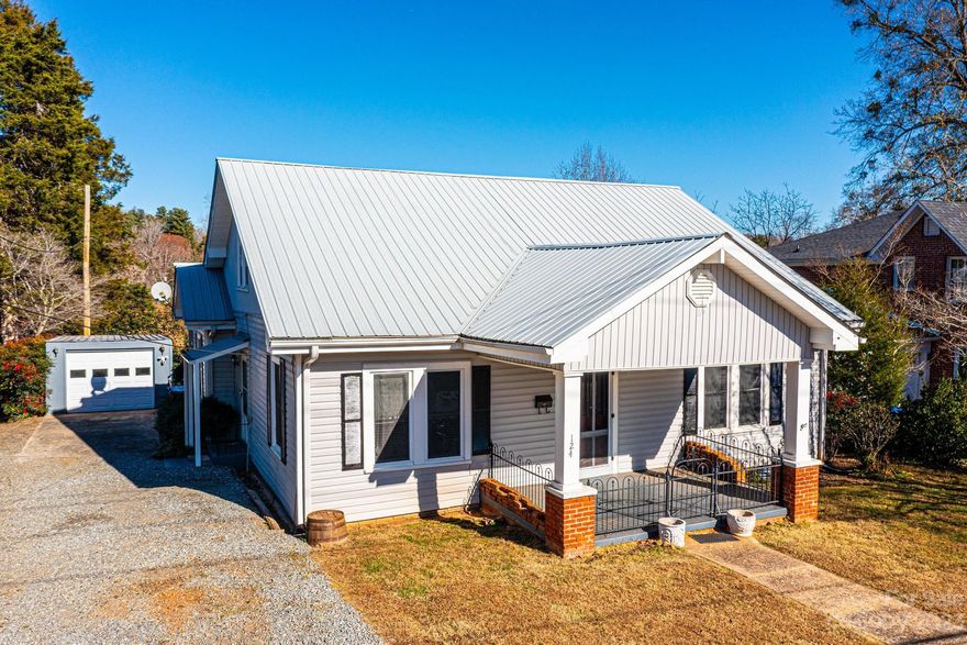 Walk to Historic Downtown Rutherfordton! This updated home built in 1910 offers Main level living. Enter from the covered front porch into the foyer leading to LR w/corner gas FP, DR w/window seat, Updated kitchen w/6 burner gas range, stainless refrigerator, microwave drawer, new counters, new lighting, new cabinets, oversized stainless sink overlooking your private backyard. Full BA w/walk-in shower. Main level BR w/large closet. Flex space with access to the side entrance. 2nd floor with 2 BRs & a full BA, don’t miss the secret space behind the bathroom Shelves. Deck off kitchen, separate workshop, fenced backyard. Easy access to Kiwanis Park w/dog park, Purple Martin Greenway, restaurants & shopping. Short drive to Lake Lure, Forest City, Black Mountain, Chimney Rock, Asheville, Charlotte. www.visitncsmalltowns.com/towns/rutherfordton/ Driveway is shared. 2nd Level BR, Full BA & stairs are heated by individual electric heat. Window units are used during summer months on 2nd floor.