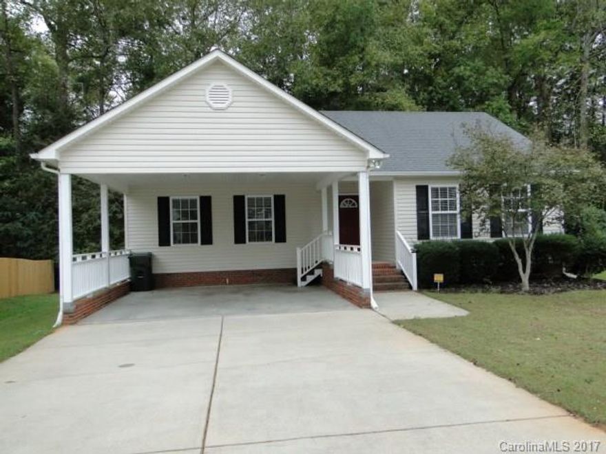 Cute and cozy ranch in a quiet Rock Hill neighborhood close to everything. The family room has a corner fireplace and vaulted ceiling opening to the eat-in kitchen. Split bedroom plan, master has a generous walk-in closet, double vanity and garden tub. Deck right off the kitchen is convenient for grilling and enjoying your morning coffee.  Carport has extra stairway to porch to keep you out of the rain.