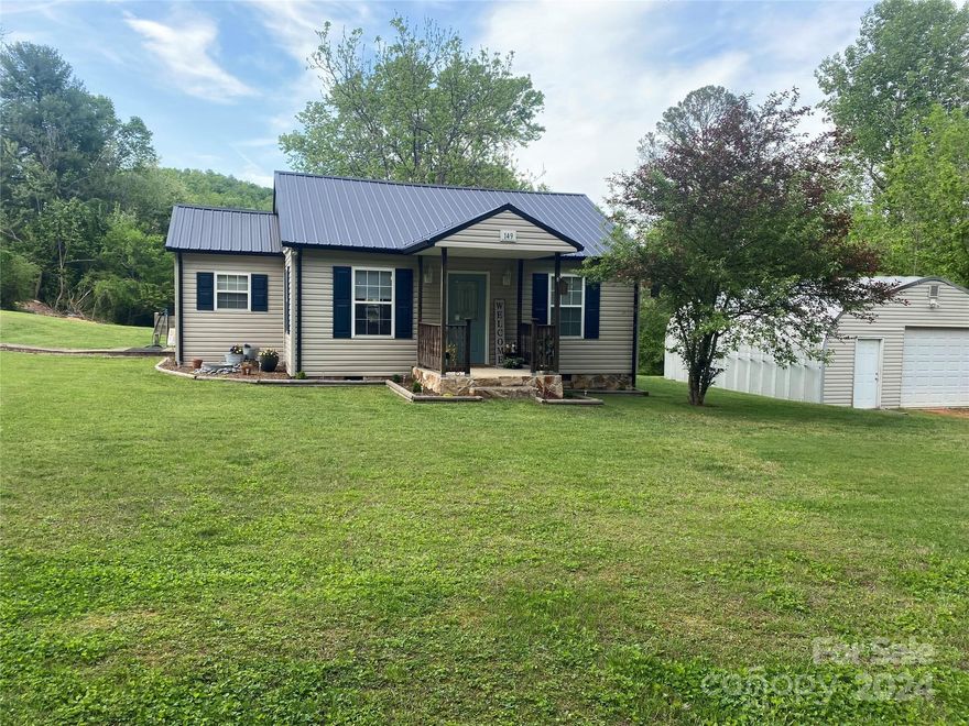 Cute home for a first time home buyer! Move in ready but has lots of room for improvements! 2 bedrooms, 1 bathroom on one level. This home has a covered front porch and back porch, a detached one car garage, and an outbuilding! Top driveway is a shared driveway.