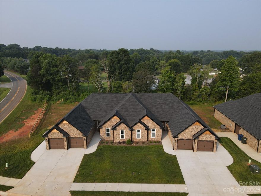 Hickory’s newest luxury townhome subdivision located in Northwest Hickory just 1 mile from Catawba Springs golf course.  These townhomes feature a full brick exterior with two car garage along with a 3rd garage door for golf cart storage all on one level. Inside you will find ample natural lighting and 9-foot ceilings all on a ranch style, open concept layout. 10-foot boxed ceilings featured in the primary bedroom and living room. Large primary bedroom and bathroom including double vanity, linen shelving, walk in shower and large walk-in closet. Relax on your covered back porch with natural woods surrounding the entire property or drive your golf cart over to nearby Catawba Springs and enjoy your dining membership, included with every townhome.