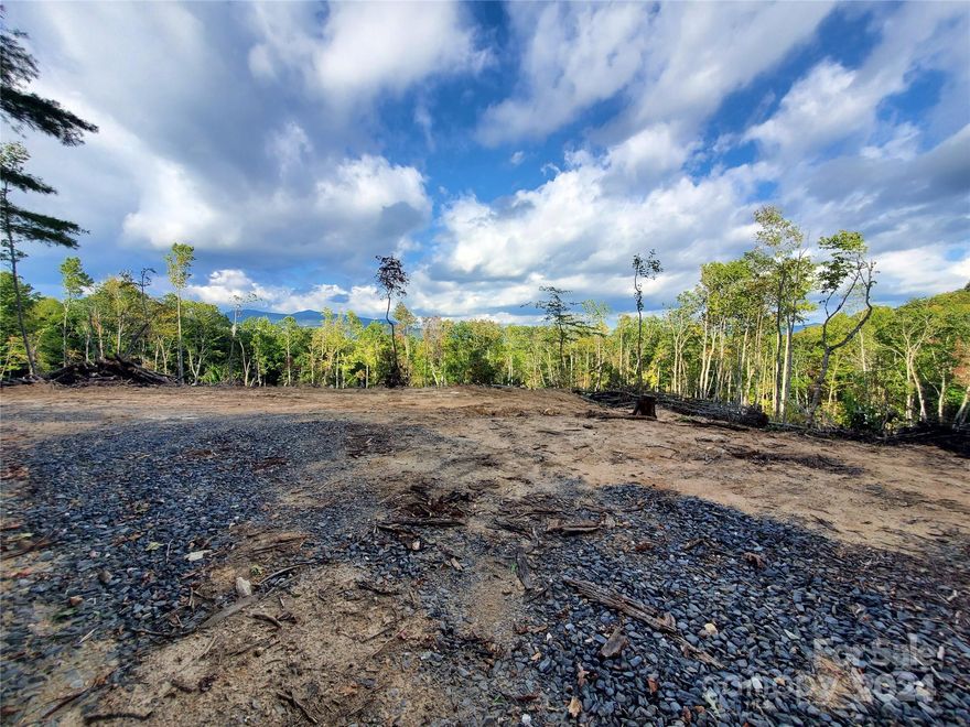 31 acres with long range views with several small streams of water and a Mountain Spring. Elevation is 3000+ feet for those cool mountain summer breezes. Extremely private tract but less than a 10 minute drive to the local hospital, Walmart, local restaurants and shopping. The Blue Ridge Parkway, hiking trail, numerous waterfall trails & Toe River (a favorite kayaking and fishing river) near by. Grassy Creek Golf course is also a short drive. Or if you are into getting away from everything and have your own private Mountain Retreat, this works for that too. All of this located in about an hours drive from Asheville, Boone and Johnson City, TN. Town water at the road and possible hook up to the municipal sewer system. Three acres of this property will not allow mobile homes, 28 acres are unrestricted. There is a possibility that this tract might have minerals that are native to this area that doesn't exist in other areas, would need to be confirmed by a Geologist. (Broker Interest)