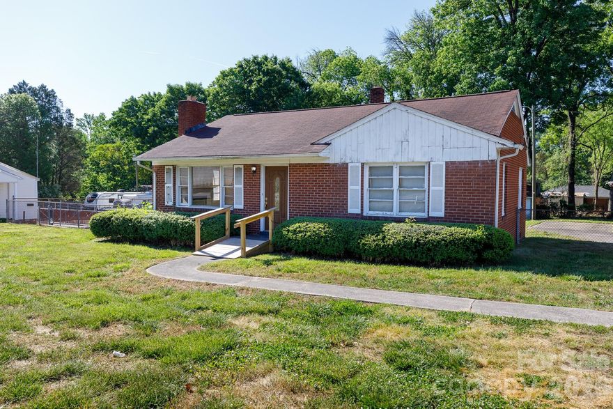 Rare commercial opportunity with high visibility on Celanese Road. This brick professional space is located strictly within York County jurisdiction, offering the distinct advantage of No City Taxes. Currently zoned Neighborhood Commercial (NC), this property is a prime choice for professional services such as legal, accounting, insurance, or medical administration. The interior offers a functional 1,247-square-foot layout featuring a dedicated reception area and three private rooms that can serve as individual offices or a conference suite. A full kitchen and a large utility area provide excellent employee break space and significant storage capacity. This property is a blank canvas, perfectly positioned for a light renovation to align with your brand's aesthetic. The exterior includes a handicap-accessible ramp at the front entrance, a paved driveway with a carport, a storage shed, and a fenced backyard for added security. Located just minutes from I-77, this site ensures maximum exposure.