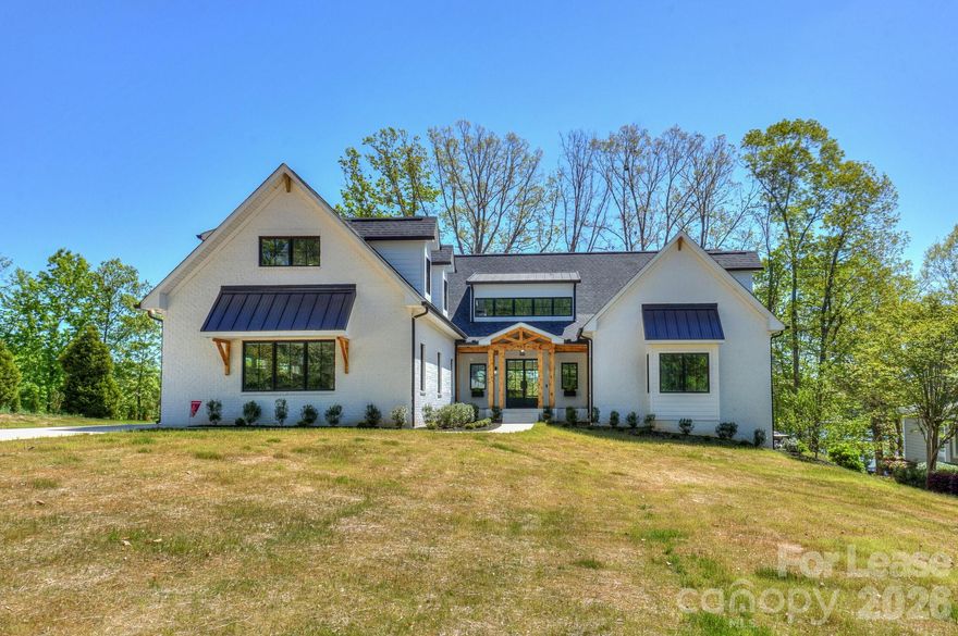 It is rare for a home of this caliber to be available for rent on Lake Norman. This exceptional, custom built home has been built with the highest quality materials and care. This 6,300 square foot home with a full walk out basement features 4 bedrooms, 5 full and 1 half bathroom, exercise room, office, several bonus rooms and an abundance of storage. The main floor of this stunning home features a soaring 2 story family room with beautiful fireplace and built-in's, floor to ceiling windows overlooking Lake Norman. The family room blends seamlessly into the entertainers kitchen featuring custom cabinets & Level 5 premium Panda White Quartz on the counters and back splash for a dramatic, show stopping style. Massive eat-at bar, commercial grade appliances and a huge walk in pantry make this kitchen a chefs delight. The private dining room leads to an oversized screened in porch connected to the huge deck! The home also features 2 primary bedrooms on the main level with a shared black & white bathroom with luxurious soaking tub and rain shower. Both walk in closets have custom closet systems. A lovely laundry room with direct access outside and powder room complete the main level. The main floor has direct access to the 1,000+ square foot 3 car side load garage. Upstairs features a lovely loft with lots of closet storage, 2 large bedrooms with private bathrooms with dramatic cabinetry, quartz counters, floor to ceiling tile showers and large light filled windows. The huge bonus room has a private black & white bathroom with quartz counter tops & floor to ceiling tile shower.  The walk-out basement features a family room, exercise room, office and flex space. There is also a reverse osmosis water filtration system housed in the basement. The dramatic black and white bathroom has a door with direct access outside - my favorite feature - now wet towels and swim suits can be dropped off in the bathroom and not run through the house! The backyard leads to a beautiful staircase leading to your private, covered dock with boat and jet ski lifts. This is a deep water dock on a quiet cove. Across the cove a is quiet, well maintained, private marina with very little boat traffic. Beyond the marina you see endless water, trees and can even catch a glimpse of the Vitale Lakeside (formally Queens Landing) a new restaurant & lounge on the lake. You can drive your boat right there or to the other dining & entertainment options throughout the lake. The home is located in beautiful Pinnacle Shores that offers a pool, club house, boat storage, etc. While you have a peaceful location on the lake you are only a few miles from a new Publix, restaurants, dining & entertainment. Small/Medium dogs are allowed - breed restrictions apply - NO CATS. Home is also listed For Sale.