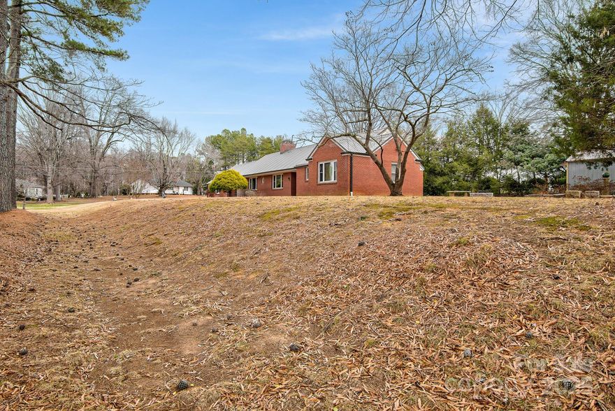 Small Town Living – Big City Accessibility

Experience the perfect blend of tranquility and convenience at 512 Gold Hill Ave. Nestled in the 'small town America' community of Rockwell, this charming all-brick ranch offers the expansive space you’ve been searching for, both inside and out. If you’ve been looking to escape the hustle of the city without sacrificing a reasonable commute, this property belongs at the top of your list.

Space to Grow & Room to Breathe
Situated on a generous 1.36-acre lot, this property offers rare "elbow room" within town limits. With over 2,164 square feet of main-level living space, the home currently features a spacious 2-bedroom, 1-full, and 2-half bath layout.

Looking for more? The full unfinished basement provides a massive footprint for future expansion—perfect for a home theater, workshop or the ultimate recreation room.

Solid Timeless Character
This home is ready for your creative cosmetic updates and modern personal touches, with undeniable quality of construction. Key features include:

*Full Brick Exterior: Durable, classic, and low-maintenance.

*Newer Metal Roof: Peace of mind for years to come. Gutters installed with roof. (2018)

*Newer Gas Furnace and Central Air: Forced air gas furnace, not a heat pump. (2022)

*Newer Water Heater: Electric water heater. (2022)

*Out Buildings: 10x12 shed and 12x20 shed for yard storage.

*Original Oak Flooring: Beautiful hardwood floors run through the primary bedroom, entry, hall and living areas, waiting to be polished to their original luster.

The Location: Central to Everything. Rockwell offers that coveted "small town" feel while keeping you remarkably close to North Carolina’s major hubs. Whether for work or weekend adventures, you are just a short drive from:
*Charlotte: 25-30 mins
*Mooresville: 25-30 mins
*Winston-Salem: 40-45 mins
*High Point: 40-45 mins
(All distances are approximate)

Don’t miss your chance to claim your piece of the Carolina countryside with city convenience at your doorstep. Schedule your showing today!