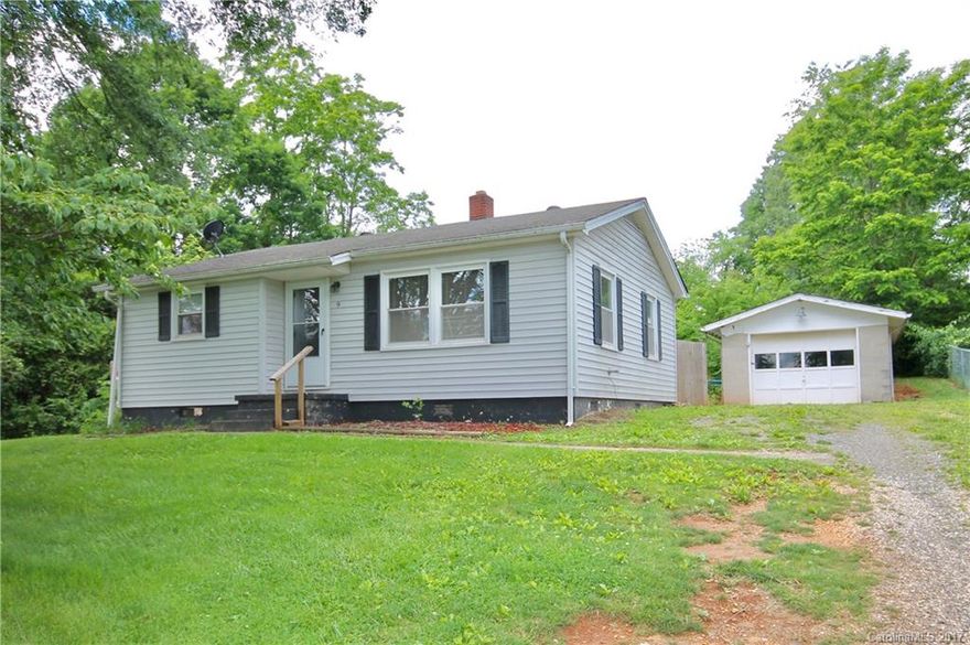 Great investment property!Updated floors in this cute bungalow in Candler. Detached garage/storage unit included as is lots of privacy.  Wonderful possibilities in your large yard.  Check this one out today!