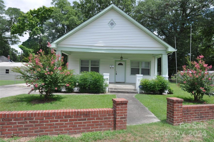 Three bedroom one bath Cottage home on .7 acre corner lot.  Lots of fencing and wired storage buildings. 10 foot ceilings in living room, dining room and two bedrooms.  This home features character and lots of potential.  Bathroom is ready for your style and design.  Kitchen offers plenty of counter top space.  Storage buildings are wired.  Detached wired one car garage with plenty of room for storage.  Clean cl100.  Great investment property or come make this house your new home.