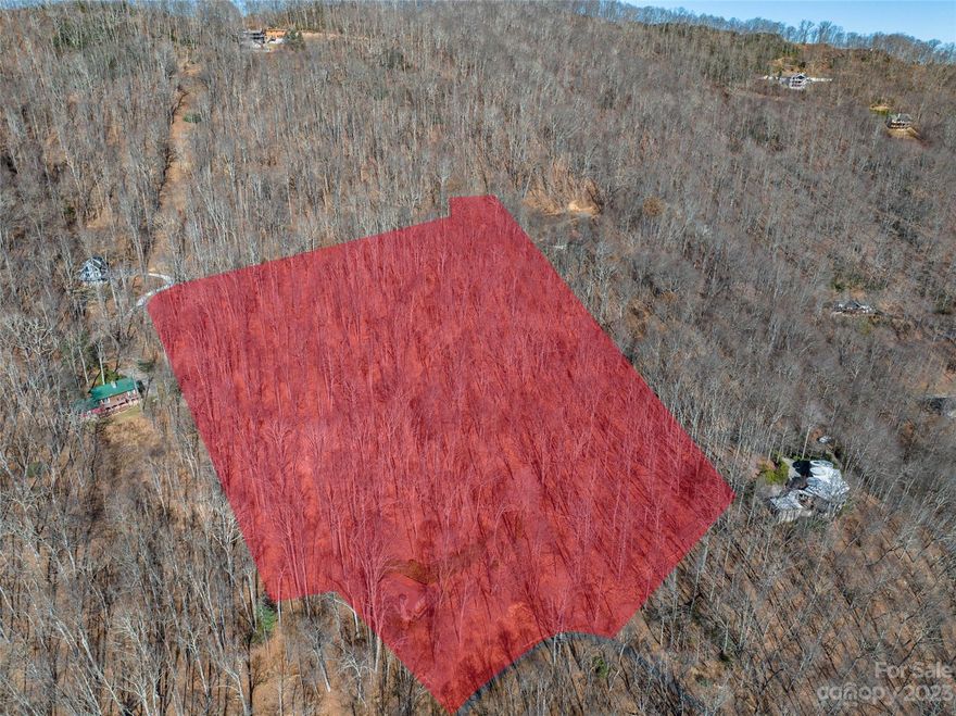 Discover a rare opportunity to own 9+ acres of pristine land in the coveted Eagles Nest Mountain area, nestled above the prestigious Laurel Ridge Country Club. This expansive parcel offers winter mountain views and paved, year-round access, ensuring convenience in all seasons. Perfectly suited for your dream home or retreat, this vacant lot provides endless possibilities for private estate or possible development in a serene, high-elevation setting. Note that the property is being sold as vacant land,with no value assigned to the existing home; a septic permit is not on record with environmental health. Home inspection and NC Geological Survey map are available to potential buyers, offering valuable insights into the property’s potential. Surrounded by the natural beauty of the Blue Ridge Mountains, this parcel is ideal for those seeking privacy, tranquility, and a connection to nature. Don’t miss this unique chance to build your vision in one of the most desirable areas of the region.