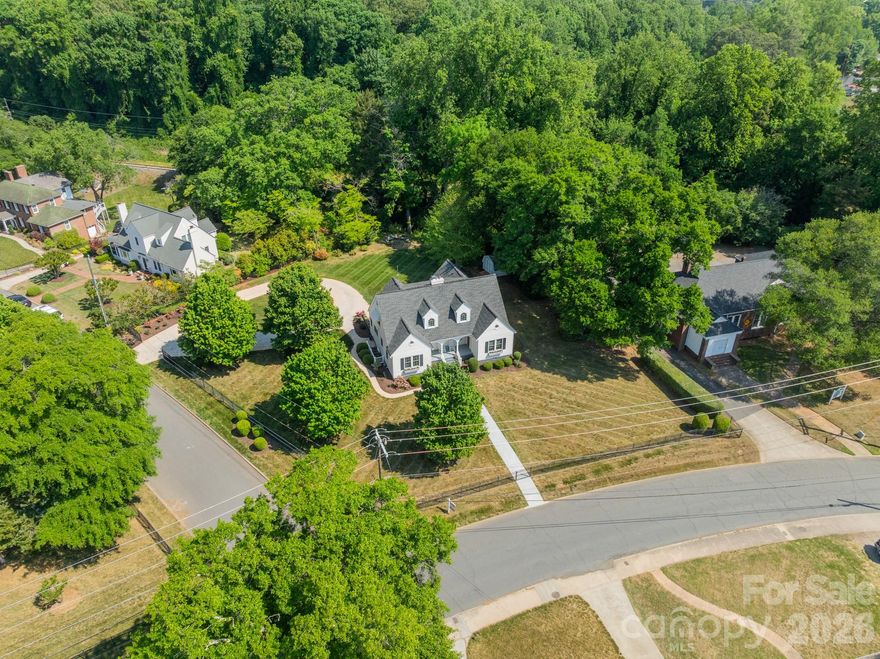 A very special and one-of-a-kind property is offered for sale at 27 Circle Drive in downtown Belmont NC. Very few downtown homes offer such a wonderful homesite - this home features a 0.75-acre fully fenced and level lot. The current owners purchased the property in 2007 knowing there was a lot of work ahead of them since the home was not in good condition. Since that time, all of the right steps have been taken to bring the home into solid condition, plus being upgraded in so many ways. There is so much history to this property starting with the original plat from the Dr. W W Davis Estate where several lots were combined to create this homesite. According to the NC State Historical Society, this home is known as the Dr. Roy H McDowell House - a beloved family physician in Belmont - his legacy can be seen on display in the Belmont Historical Society and on display in the home. As you walk through the home, you will see several doors that were used back in the day for patients to come and go! Amazing!! Almost $300K worth of improvements have been made to this home by the current owners with so many of them not readily seen such as - forty new high-end Pella windows, new doors, new crawlspace vapor barrier, insulation, and preventative treatments, structural remediation, new roof, new HVAC's, new fencing, new shed, new tankless water heater, updated plumbing, plus more! Then, the owners took care of the beautiful things you can see - a totally new kitchen and appliances, updated baths, new landscaping, added two laundry locations, new front walkway. Inside this beautiful home, you will find wood flooring on both levels in all rooms except the baths which are tiled. There are lots of windows and the home takes in so much natural light - it's lovely on a sunny day! There are two opportunities for a primary bedroom location - one on each level.  Storage is no problem with two walk-in attics plus a pull-down attic. Remember the shed too for outdoor implements. If interested, the owners had a plan drawn for a detached apartment along side the circular driveway. If you're familiar with Belmont, then you know how incredible this location is - use your golf cart or walk to all that downtown Belmont has to offer! If you've never been to Belmont and are looking for a robust yet quieter lifestyle that small towns offer, come take a look - you will be impressed. Belmont offers close proximity to the Charlotte Douglas International Airport, easy highway access, restaurants, bars, shops, a park, city festivals, close to Lake Wylie for boating, and more! The owners are so excited to offer their home to the next owner to love it as much as they have - come take a look!