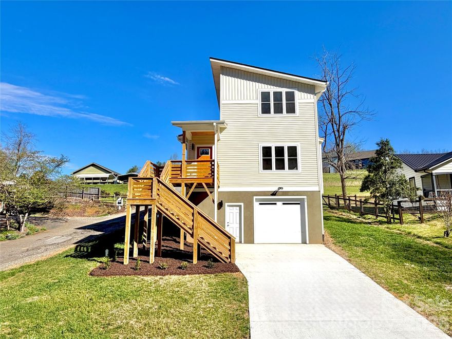 New Construction in Mars Hill city limits! PRIME Location!!  
This modern design, 3 BR, 2.5 BA home is conveniently located to downtown Mars Hill, giving you easy access to the university, shopping, dinning and other amenities!
This home offers the perfect balance of style and comfortable living with many high-end finishes featured throughout. Beautiful granite countertops, floor to ceiling tiled shower and a cozy gas fireplace just adds to this home’s sleek interior.
You’ll appreciate the numerous windows, allowing for natural sunlight and providing those beautiful long range mountain views from the upper level.
Your primary suite, laundry, kitchen and living area can be found on the main level while 2 additional large BR’s and a full size bath is located on the upper level. 
PLENTY of storage throughout including a basement with a drive-in garage.
Short term and long term rentals are allowed, providing investment potential! Convenient to Weaverville and Asheville for your everyday commute. This property has lots to offer and is a must see!
*This home is not tract built, it is a custom plan designed and constructed by a local, reputable builder.