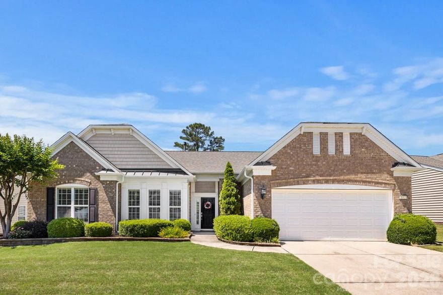Welcome to this beautifully maintained Crestwood Meadow home in Sun City Carolina Lakes! Just off the foyer, French doors open to a private office or study, offering the perfect space for remote work or quiet relaxation. Two spacious secondary bedrooms and a full bath are tucked along the hallway, providing comfort and privacy for guests.

The heart of the home features an open-concept layout ideal for both everyday living and entertaining. The great room is highlighted by a gas log fireplace with elegant mantle and picture frame molding details, while the formal dining area with tray ceiling and chandelier adds a touch of sophistication for gatherings and special occasions.

The kitchen is designed with both style and function in mind featuring granite countertops, stainless steel appliances, tile backsplash, a large island with seating, and seamlessly flows into the breakfast area and sunroom. Natural light fills the space, creating warm and inviting views of the backyard.

Privately located at the rear of the home, the spacious primary suite offers a relaxing retreat with an ensuite bath that includes a dual sink vanity and walk-in glass shower.

Outdoor living is just as inviting with a custom paver patio perfect for enjoying peaceful Carolina evenings in the private backyard, framed by mature shade trees with views of the lake beyond.

Living in Sun City Carolina Lakes means enjoying resort-style amenities including golf, indoor and outdoor pools, tennis and pickleball courts, walking trails, water access, and social clubs!