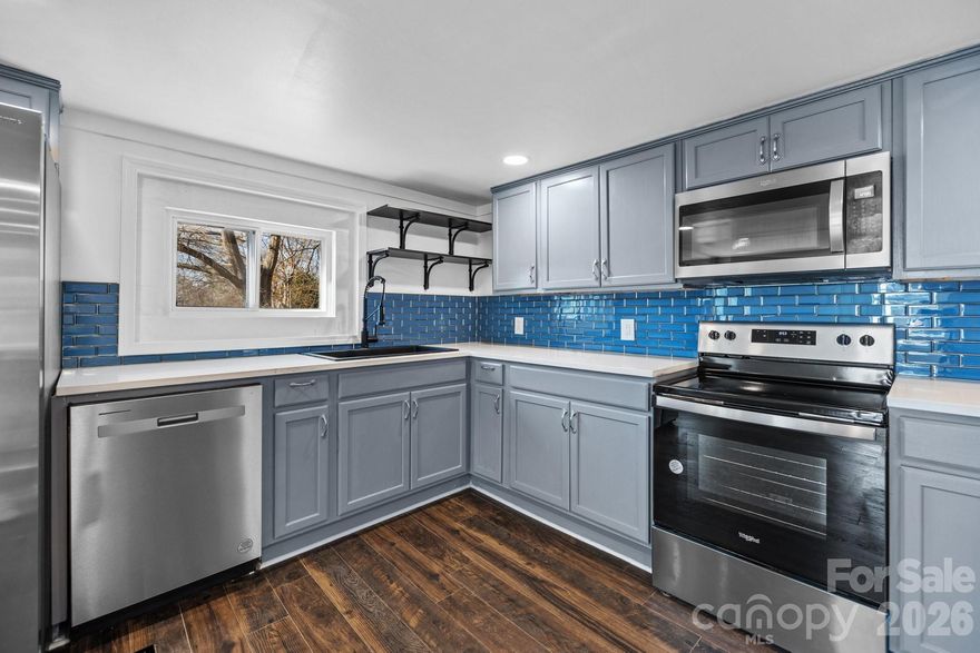 BEAUTIFUL and SPACIOUS - fully renovated home in Stanley, NC! Located within the quaint Stanley town, this home is only a few minutes from your essentials, 20 minutes from the US National Whitewater center, 25 minutes from the int. airport, and only 30 minutes from Uptown Charlotte. This home sits on a gorgeous corner lot with lots of room for outdoor grilling and gardening! The interior features dark wood floors throughout, white walls, accent cabinets with tons of storage, new quartz countertops, new accent tile backsplash, NEW SS appliances in the kitchen, and a beautiful fireplace insert on a tile accent wall in the living room. On the main floor of the home, you will find the laundry room conveniently located close to the primary bedroom, which is also attractive for anyone who is looking for a bedroom on the main level. Upstairs you will find 2 spacious bedrooms with large walk in closets and a beautiful luxury full bath. Come see this home for yourself and make it your own!