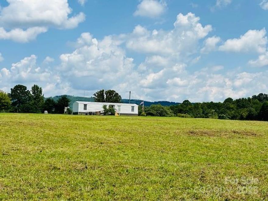 Looking for level acreage with a year round mountain views? Take a look at this 4.08 unrestricted parcel that offers so much potential with road frontage on 2 roads! 1990 single wide mobile home has a family room, kitchen, dining area, primary bedroom, full bath tub/shower, 2nd. bedroom, and laundry area with access to the back door. Handicapped ramps to enter at both doors. Open lot with some trees at the front and back borders. Schedule your appointment soon!