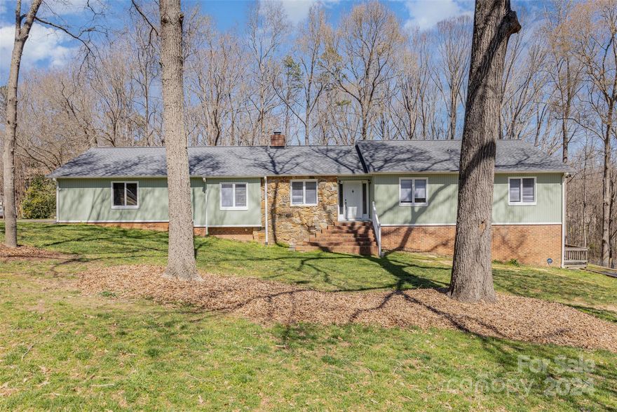 Private Retreat nestled in the trees in beautiful Olde Williamsburg of Fort Mill! A rare find with No HOA! Unique floor plan perfect for a multi generational family or looking for rental income! On the main level you will find the main living space w/updated kitchen & large living room w/expansive stone fireplace. New floors and paint throughout! Kitchen has granite counters, SS appliances & tile backsplash. Large primary has updated en-suite & walk in closet. 3 more bedrooms & 2 full baths complete the main space. Main level also has an apartment w/separate entrance perfect for rental or Air BNB potential. The fully finished basement has separate entrance & driveway! It contains a kitchen, living room, 2 bedrooms and full bath. 2 new wood decks allow you to enjoy your 1 acre backyard! You can make this home your own personal oasis yet still be close to Parks, Schools, Restaurants on Main, Kingsley, The Greenway, Riverwalk, and so much more!