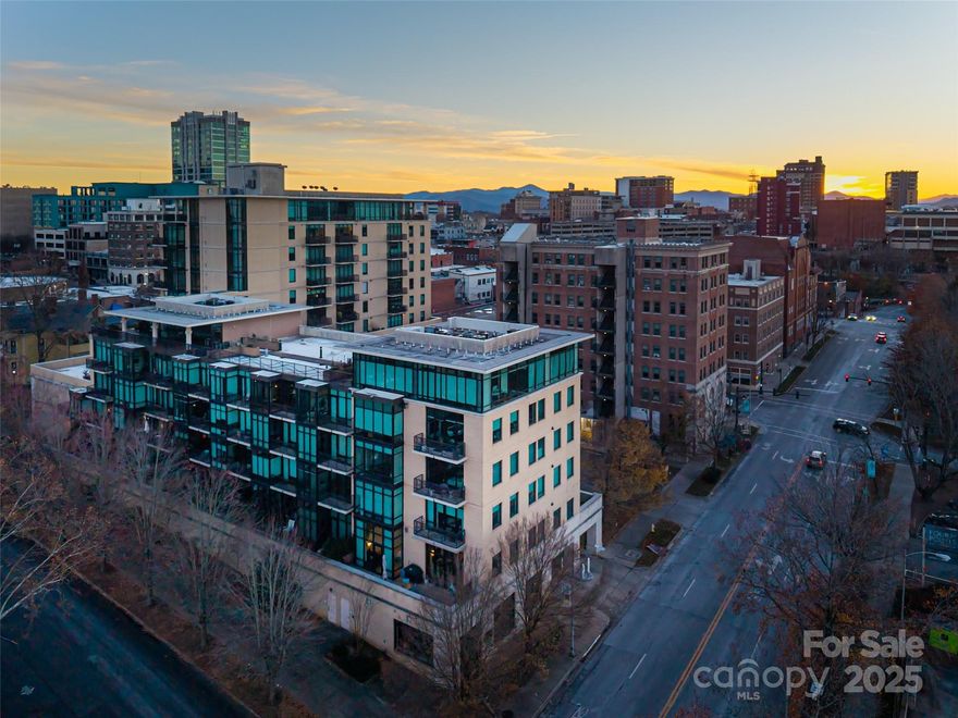 The rare combination of luxury, location, and privacy is immediately apparent as you enter this premier corner residence just steps from the heart of downtown Asheville. The open layout features floor-to-ceiling glass and 1,820 sq ft of refined living space, complemented by nearly 1,000 sq ft of private outdoor terraces with north, east, and west exposures. Three bedrooms, two full baths, and one half bath include two bedroom suites that open directly to outdoor living. Interior upgrades include motorized Hunter Douglas blackout shades and a kitchen outfitted with new GE Café Series appliances. Additional features include high ceilings, walk-in closets, a full laundry room, and two parking spaces in a secure garage.

Residents enjoy scenic decks and walkways and the full suite of amenities at 60 N. Market, including a rooftop terrace, club room with panoramic city views, 24-hour fitness room, and a full kitchen with outdoor grill. Condo dues include cable, internet, trash/recycling, and water. This sought-after address is just blocks from downtown Asheville’s best dining, shopping, theaters, galleries, cocktail bars, and more.