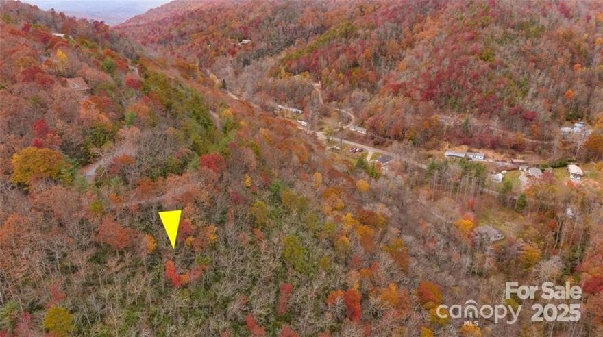 Perched above the noise this lot features year round long range mountain views, privacy, and an adjacent creek. The 6.8 MOL acre homesite is located 30 minutes from Asheville and 15 from Black Mountain. Numerous State Parks, outdoor activities, breweries, and restaurants easily accessible. Come build your dream home with a Southern face and mountain views in this quiet high-value neighborhood.