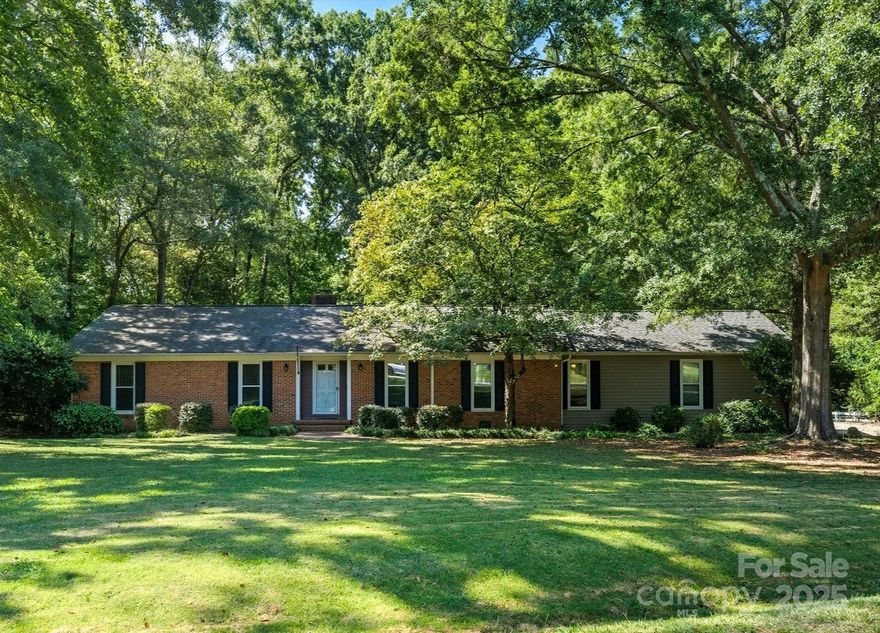 Take advantage of this Price Improvement! A Rare Find in Fort Mill! Charming brick ranch situated on an almost 1 acre, private lot, bordering the 4th fairway of the Fort Mill Golf Club! Enjoy the tranquility of "country style" living with no city taxes and no HOA. This delightful 3-bedroom, 2-bath home features original hardwood floors, a covered carport with ample storage, and a welcoming back porch that overlooks a peaceful, "park like" yard with mature trees. Located in the award-winning Fort Mill School District, you’re just a short walk to Main Street, shopping and fantastic dining. Whether you're looking for a peaceful retreat or the perfect place to create your dream home, this property offers incredible potential and all at an affordable price! Fireplace is wood burning and sold As-is with no known issues. Seller agrees to disclosed dual agency.