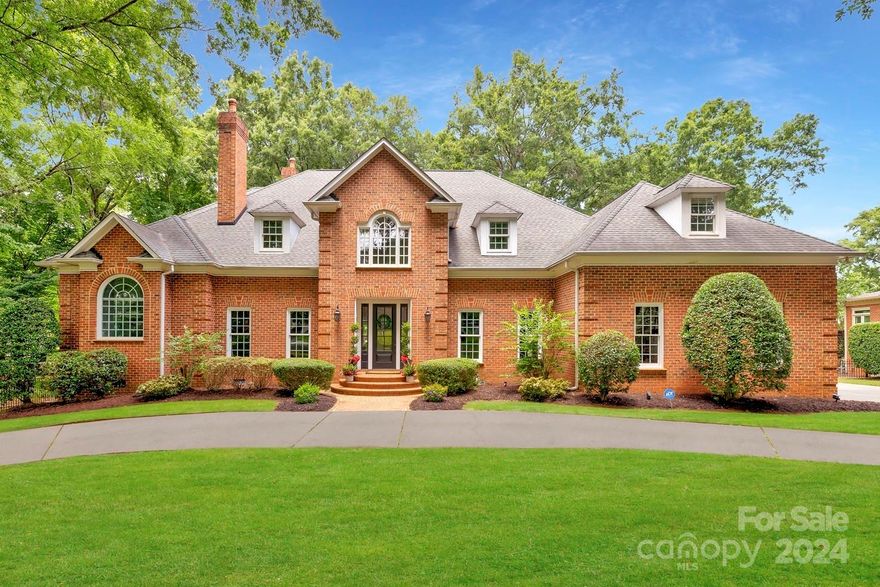 This exquisite brick residence located in Providence Country Club is perfectly positioned on the fairway of the 15th hole. Luxury greets you at the front door with an elegant curved staircase and thick crown molding throughout the home. Boasting 5 bdrms including 2 primary suites and 3.5 remodeled bathrooms. The primary suite on the main level offers sweeping views of the golf course. The kitchen was redesigned in 2023 to include a media pantry for charging electronics, a 10-foot island with quartz countertop/backsplash, Bosch appliances, double ovens and a butler's pantry. Refinished hardwood floors flow throughout the main level, bonus rm and upstairs hall. The upstairs carpet was installed in 2022. Two inviting gas-log fireplaces. Abundant storage options throughout. Step outside to your private, fenced-in backyard, ideal for outdoor gatherings and play, all situated on a generous .74-acre lot. Mature trees offer privacy. The 2-car garage offers extra space for your golf cart.