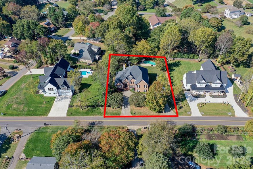 Full brick home with 4 bedrooms, 4 full bathrooms, office, and flex space/playroom. Home has just over 4200 sqft of living space. New roof installed 12/2024. Wood floors throughout. Large lot just under half an acre (.46). Very private backyard that is fenced with a pool and pergola. New pool pump was just installed. Garage has been converted to a finished work space that is heated and cooled by a ductless mini split system. Garage can be converted back and/or there is the possibility and enough room for a detached garage to be added. There is a primary bedroom on both the first and second floor. Both primary bedrooms have a dual vanity, walk-in shower, and separate jetted tub. Kitchen has custom cabinets, stainless steel appliances and granite counter tops. Large two story great room has wood burning fireplace and built-ins. Great location towards the end of street with partial lake view. Finished square footage includes 485 sqft of finished garage area. Garage can be converted back into a garage if the buyer wants an attached garage.