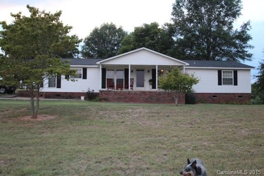 Spacious home on approximately 14 acres. Home features Eat-in kitchen, family room w/ gas logs, great room/dining room and spacious laundry. Owners suite has WIC, separate shower/tub and built-ins in bath. There is a deck off back, concrete front porch over looking private yard & attached 2 car carport. Detached 1 car/garage, shop with power & H2O. Barn. The 14 acres features a pond.