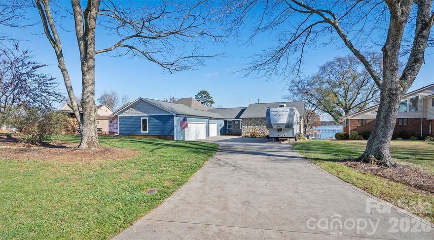 Experience extraordinary main-channel views and timeless waterfront living in this beautifully maintained 3-bedroom, 2-bath ranch on Lake Norman. Positioned to capture wide, open water, this home offers stunning sunrises, peaceful moonrises, and shimmering reflections from nearly every room—an exceptional vantage point rarely found.

Located in a welcoming, well-established community with no HOA, the property provides both freedom and convenience. Friendly neighbors, a comfortable sense of privacy, and the ability to park your boat or RV at home all enhance the appeal.

Inside, the great room features hardwood floors and a wood-burning stove, creating a warm and inviting central gathering space oriented toward the lake. The updated kitchen offers granite countertops, a Bosch gas range, double ovens, and excellent storage, including a walk-in pantry. A thoughtful drop zone off the garage adds everyday functionality. The dining room includes custom built-in cabinetry, and both bathrooms have been updated with skylights that bring in soft natural light.

A standout feature is the screened porch that spans the length of the home, offering the perfect place to enjoy lake breezes, morning coffee, and year-round views. This space also includes a hot tub and sauna, creating a private retreat for relaxation.

Outdoors, the property shines with a large grassy backyard ideal for play, gatherings, and enjoying the outdoors. The 10,000-gallon Gunite pool sits on the lake side and becomes surrounded by lilies each spring through August—a unique and beautiful seasonal touch. The gently sloping lot leads to your private waterfront, complete with a dock, 2 boat lifts, and 8–10 feet of water at full pond, offering exceptional access for boating and recreation.

Practical updates and features include a 2013 roof, 2017 furnace, heat pump, and central air, a gas tankless water heater, a whole-house generator, and a 4-car garage added by the sellers, providing abundant storage for vehicles, tools, and lake equipment. A dedicated wood shed supports the wood-burning stove.

Combining exceptional views, meaningful updates, generous outdoor amenities, and an unmatched main-channel setting, this Lake Norman home offers a rare opportunity to experience lake life at its finest.
