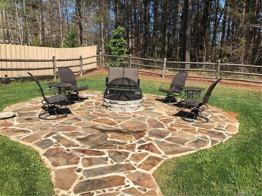 Stone walkway to approx. 18’ D. fire pit area, perfect for entertaining!  Gas stub-out for grill on 12’x18’ concrete patio. Backyard backs up to tree-filled green space. Fencing for pets. Mantle and interior front door were painted by pro decorator. Guest ½ bath has matching tile backsplash, mirror and cabinet. Stainless appl. Crown moulding most rooms. Cased windows. Bay window. Upgraded ceiling fans and chandelier. WH  audio with mounted TV to stay. Front room can be home office. 9' ceilings.