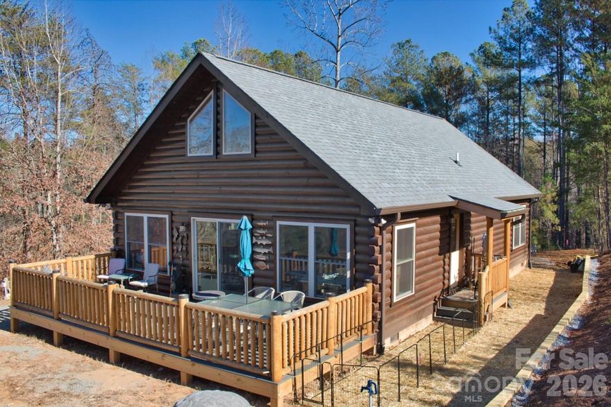 Motivated Seller! Built in May 2025, this NEW Blue Ridge Log Cabin sits on 5½ acres at the end of a cul-de-sac, in a gated community. This property offers a rare find - both a year 'round stream, and a mountain view! 

The cabin is the builder's Carolina II model, with some modifications. It's a two bed/two bath cabin with a huge, well-insulated attic (storage? a third bedroom?), located where only one neighbor shares this entire street - and you can't see them from this property! Privacy, anyone?

After driving through the cul-de-sac and following a long driveway, you'll arrive at this charming log home. Walk into a huge great room, with a wall of windows facing the sunsets and offering a view of the mountains. Abundant natural lighting fills the room, where the ceiling measures over 17' feet to its peak, and the softwood floors add to the cabin's 'genuine' quality.

The kitchen features granite countertops with a soft-to-the-touch, leather finish. Any cook will appreciate the gas range and pot-filler, and new appliances (included) are always a joy. Tall cabinets offer extra storage, paired with the large pantry!

Laundry is conveniently located in the hall bathroom, out of the way, but easy to access, while a little nook is thoughtfully tucked into the hall for your fur babies. The large, lit attic is accessed with drop down stairs, also located in the hall.

From the builders original plans, the modifications enlarged the living area considerably by removing the third bedroom and re-configuring the location of the laundry. The second bedroom is fair-sized, while the primary is massive, considering the modest 1,221 sf footprint of this cabin. It's offered partially furnished.

The two-bedroom cabin is connected to a three-bedroom septic system, with a second driveway originally created for an RV. Sitting just below the driveway is a large shed that has power and a new refrigerator.... man-cave / she-shed anyone?

Clearwater Creek is just north of Rutherfordton, the seat of Rutherford County in western North Carolina. Grocery stores, healthcare, shopping, restaurants and just about anything you need is a ten to fifteen minute drive away, and it's about an hour's drive southeast of Asheville. You've found a great location!