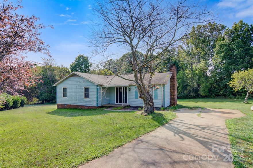 Convenient Startown location on a quiet cul-de-sac and no city taxes! This is a great starter home with 3BR/2BA on a generous 2/3 acre lot.  Hardwoods in much of main living areas. A lovely painted wood-burning fireplace is the focal point of the living room/dining area with cathedral beamed ceiling. SS appliances in kitchen. Sellers have replaced exterior front/back doors, well pump, water heater, and have had the crawl space encapsulated. The rear deck overlooks the private backyard large enough for kicking or throwing the ball of your choice! The inventory in this price range is extremely bare; call for your private showing today.