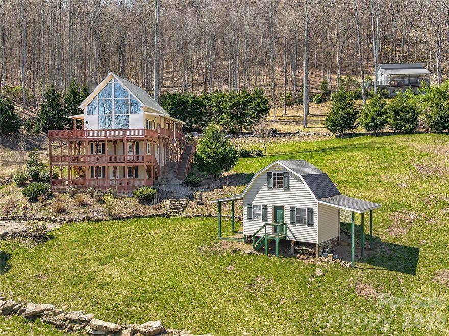 Discover your mountain haven on 2.78 acres—complete with multiple outbuildings, wide-open usable land, and endless potential for outdoor living, mini-farming, gardening, or equipment storage. This peaceful property offers the space and flexibility buyers are searching for, whether you’re looking for room for animals, a workshop, ATV storage, or a place to park your RV, camper, or boat.

Inside the home, large floor-to-ceiling windows fill the space with natural light and frame breathtaking mountain and forest views. The spacious kitchen features stainless steel appliances and granite countertops, making meal prep easy while still connecting you to the beauty outside. Wrap-around porches on every level provide multiple inviting outdoor spaces to relax, entertain, and enjoy the serenity of the mountains.

The property shines with its additional structures, including:

A 2-story outbuilding offering storage, workshop potential, or hobby space -

A 30x30 pole barn built in 2022, perfect for equipment, tractors, ATVs, outdoor gear, or boat storage -

A concrete slab with full 200-amp service, ideal for future building projects, RV hookup, or expansion.


A charming stone fire pit creates the perfect gathering spot for friends and family, surrounded by lush greenery and mountain views. With nearly 3 acres of usable land, the opportunities are truly endless.


Don’t miss your chance to own this peaceful mountain property—your private retreat with room to grow, play, and create the lifestyle you’ve been dreaming of.