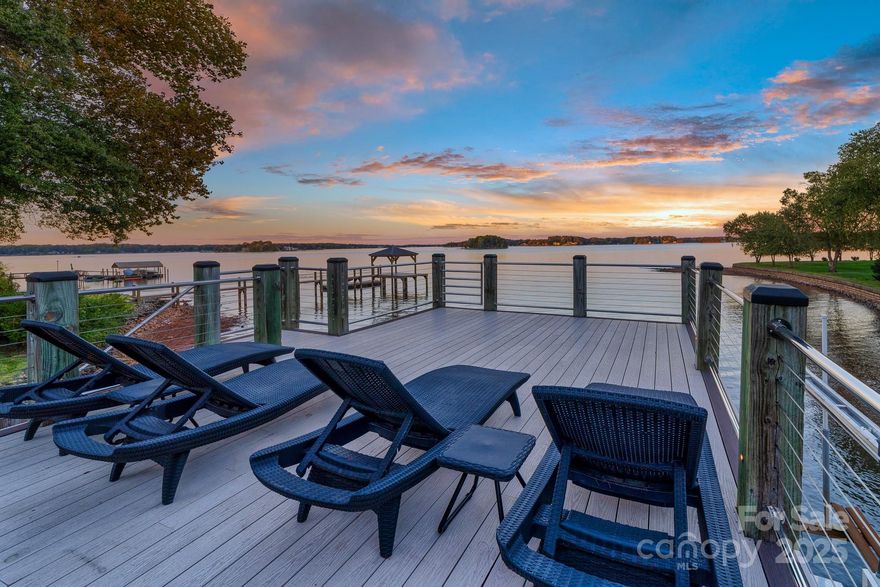Lake Norman waterfront • 0.72 acre lot • No HOA • Private dock with 2 lifts + upper viewing deck • EV-ready garage with epoxy floors. Experience panoramic sunrise views from this waterfront home on Lake Norman. Situated on over 200 feet of shoreline, 2778 Cherry Lane blends timeless craftsmanship with modern updates across 3,837 sqft of finished space and extensive outdoor living areas.The main level welcomes you with open, connected living and dining zones designed around the lake. Vaulted ceilings, skylights, and a floor-to-ceiling stone gas (propane) fireplace  create a bright, airy centerpiece anchored by wide-plank hardwood flooring. The gourmet kitchen features Jenn-Air stainless appliances, induction cooktop, double ovens, calacatta quartz surfaces, and a large central island—offering seamless flow to the dining area and deck for entertaining. A charming breakfast nook captures tranquil lake views, creating a serene setting for morning coffee or casual dining.The primary suite on the main level provides dual walk-in closets, heated tile flooring, and a spa-style bath with soaking tub and frameless shower.The main-floor features French doors that open onto a 600 sqft deck overlooking expansive water views. The 2023 remodeled lower level adds two new full baths, a bunk room, new ceramic tile flooring, and a generous recreation room with gas fireplace (propane) and direct lake access—ideal for guests, media, or multi-use space. Every detail of the lower-level living feels less like a basement and more a continuation of the home's main floor. Step outside to enjoy multiple gathering zones built for year-round use: a timber-frame gazebo, stone outdoor kitchen with stainless built-ins and grill, paver patio, and manicured lawn leading to a gentle-slope beach entry. The private dock includes a covered boat slip with lift, kayak racks (do not convey), and an expansive upper-level sun deck that captures every color of the evening sky. Additional updates include two new hot-water heaters (2023), 30-year architectural roof (2012), updated HVAC, EV-charging wiring in garage (unit does not convey), smart thermostat, and available fiber internet. Located minutes from local marinas and recreation, this property sits 0.8 mi to Beatty’s Ford Park, 1.1 mi to Safe Harbor West Port Marina, 2.6 mi to Publix and Starbucks, and 3 mi to Verdict Ridge Golf & Country Club, with quick access to Highway 16 Bypass (3.5 mi) for direct routes to Charlotte 30 minutes to Uptown and the Airport. Enjoy the best of Denver, NC lakefront living with space, privacy, and amenities rarely found together—no HOA, expansive water frontage, and functional indoor-outdoor design tailored for every season.
